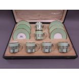 Cased set of six Wedgwood pale green and gilt coffee cans with saucers,