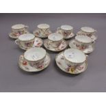 Set of nine Continental porcelain floral decorated coffee cups with saucers bearing cross swords