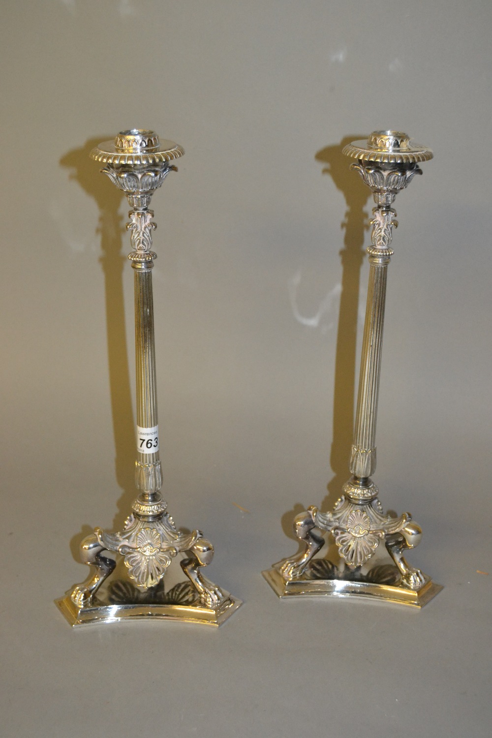 Pair of good quality silver plated cast candlesticks with reeded tapering columns and three paw