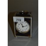 Early 20th Century silver and tortoishell cased dressing table clock having circular enamel dial