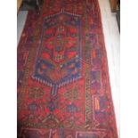 Kurdish rug with a lobed medallion and Herati design on blue and red ground with borders,