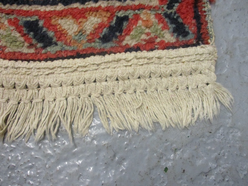 Kurdish rug with an all-over stylised medallion and floral design on a red ground with borders - Image 5 of 6