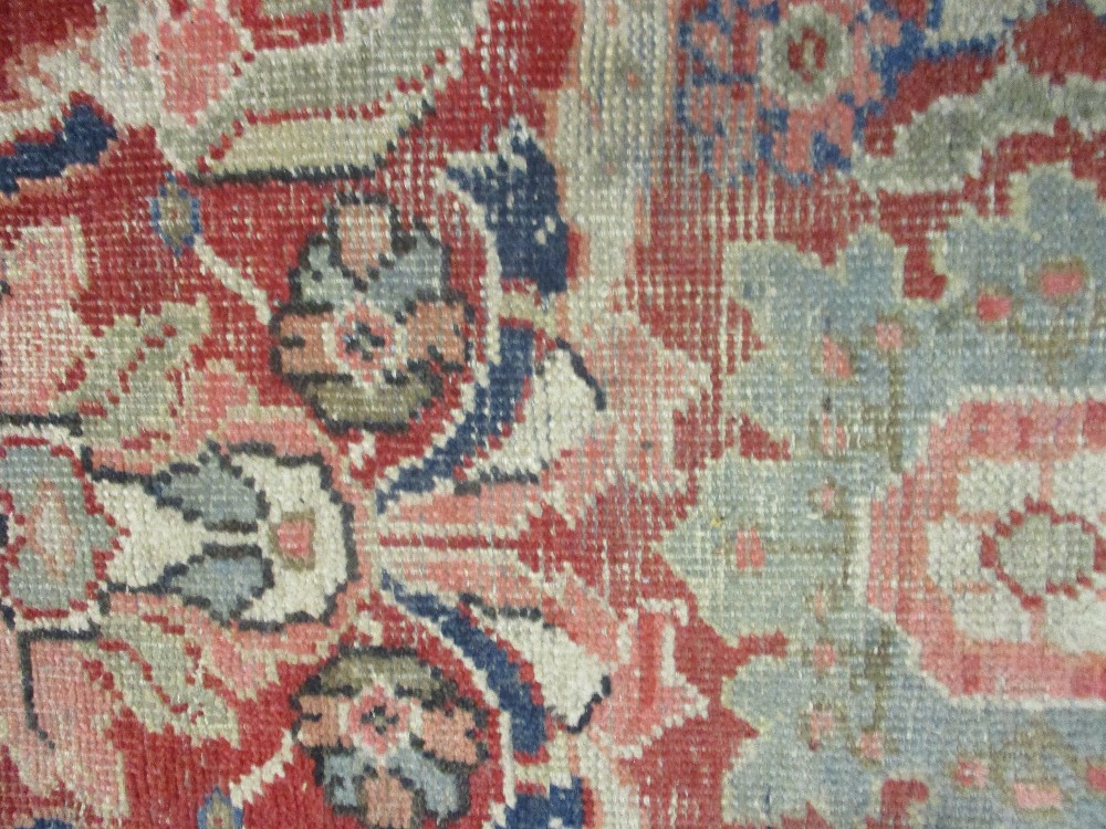 Kurdish rug with an all-over stylised medallion and floral design on a red ground with borders - Image 4 of 6