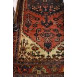 Hamadan rug with a lobed medallion and all-over Herati design on a rose ground with ivory corner