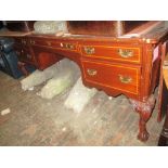 Reproduction mahogany and inlaid pedestal desk with a moulded top above five kneehole drawers,