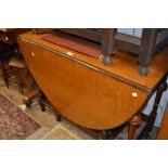 1930's Oval oak drop-leaf gate leg table on turned supports