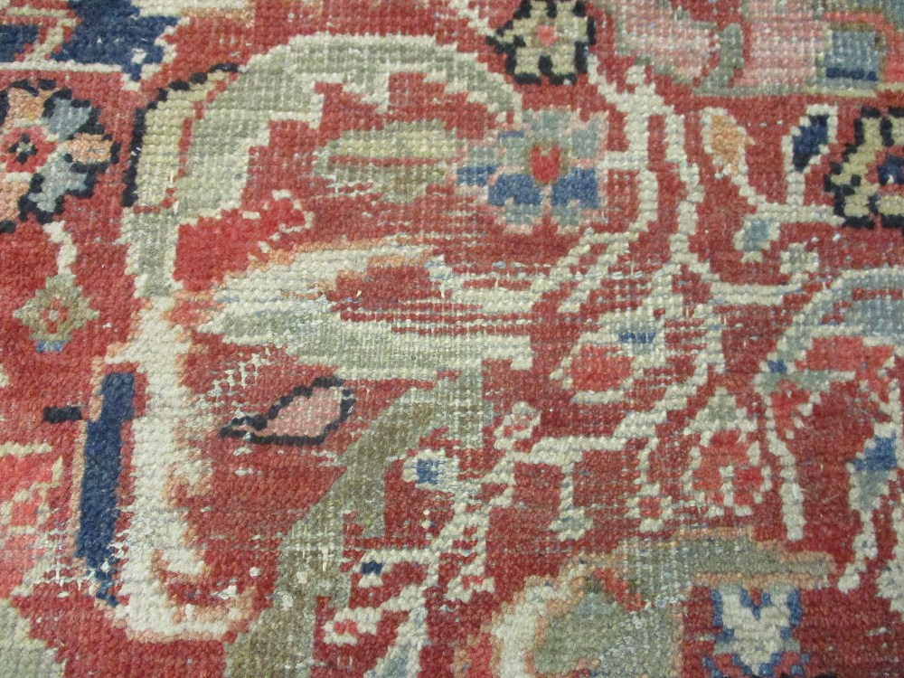 Kurdish rug with an all-over stylised medallion and floral design on a red ground with borders - Image 2 of 6