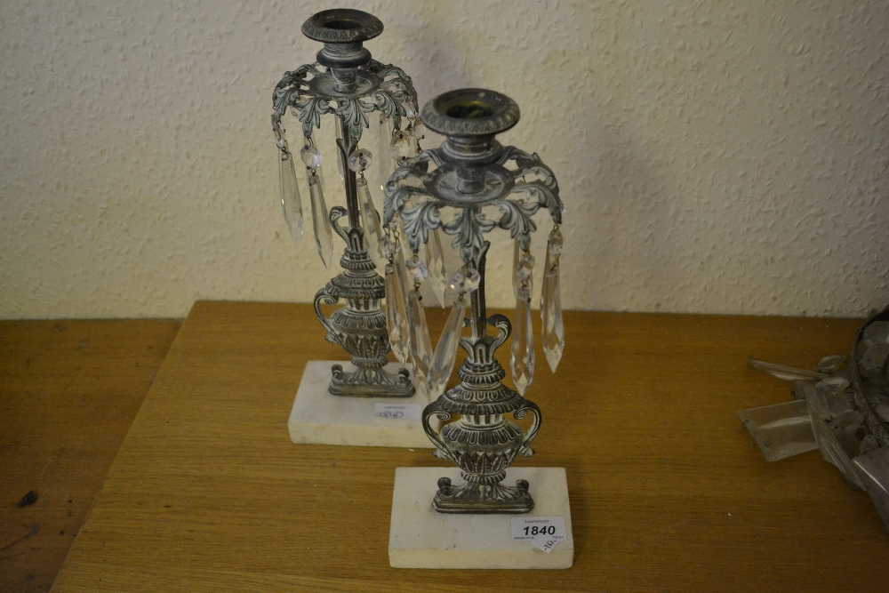 Pair of Verdigris brass candlestick lustres with cut glass drops on marble bases