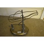 19th Century brass decanting cradle on an oval stand with turned feet