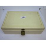 Cream jewellery box containing various costume jewellery