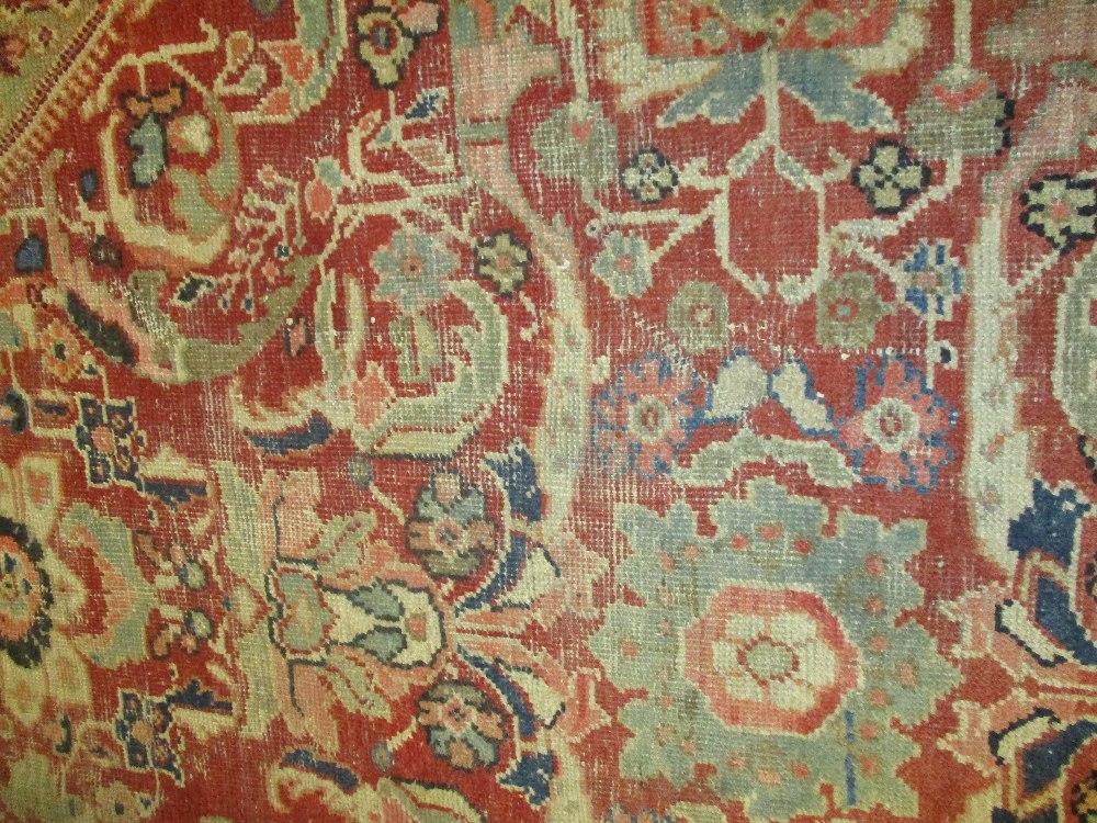 Kurdish rug with an all-over stylised medallion and floral design on a red ground with borders - Image 3 of 6