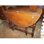 Small early 20th Century carved oak gate leg table on turned supports