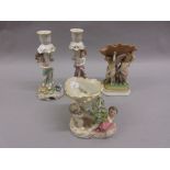 Pair of Continental figural porcelain candlesticks,