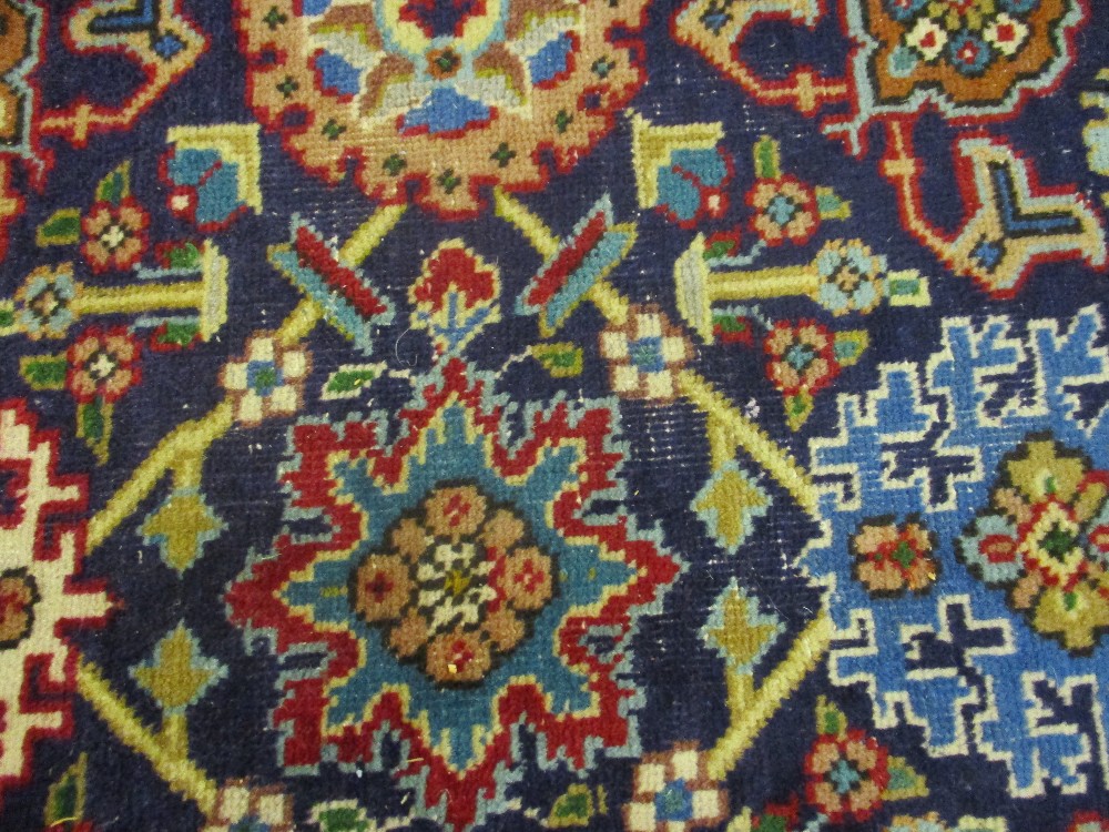 Tabriz carpet with an all-over stylised flower head design on a midnight blue ground with borders, - Image 4 of 5