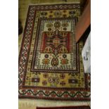 Caucasian style rug with a single medallion on a beige and ivory ground with borders,