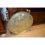 North African engraved brass tray top occasional table on a carved and mother of pearl inlaid