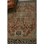 Kurdish rug with an all-over stylised medallion and floral design on a red ground with borders