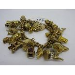 Large and heavy 9ct gold curb link charm bracelet with twenty nine various 9ct gold charms