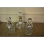 Three various silver mounted cut glass decanters with stoppers,