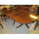 Mahogany pedestal dining table with a solid reeded top and single extra leaf together with a set of