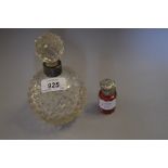 Silver collared glass perfume bottle and a red cut glass silver topped perfume bottle (lacking