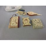Four 19th Century pierced ivory pin cushions together with a similar needle case