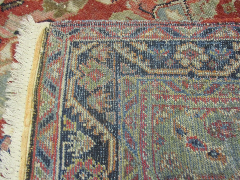 Kurdish rug with an all-over stylised medallion and floral design on a red ground with borders - Image 6 of 6
