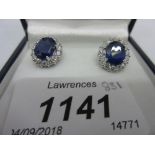 Pair of 18ct white gold sapphire and diamond cluster earrings, sapphire total 4.57ct, diamonds 1.