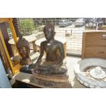 Large dark patinated and gilt decorated bronze figure of seated Buddha, 33.