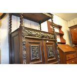 19th Century oak buffet having floral and maskhead carved decoration with two shelves,