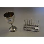Victorian silver pedestal trophy cup together with a Birmingham silver six division toast rack