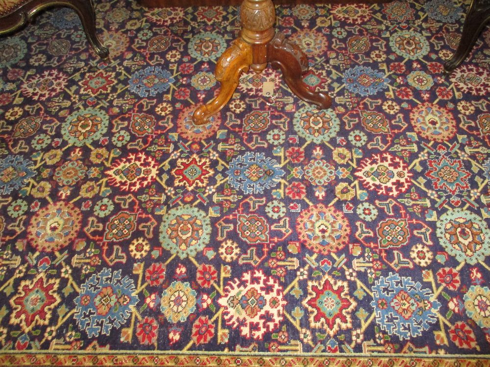 Tabriz carpet with an all-over stylised flower head design on a midnight blue ground with borders, - Image 5 of 5