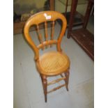 Child's 19th Century fruitwood correction chair with bobbin turned back,