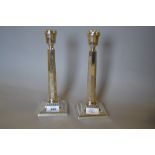 Pair of silver candlesticks of octagonal tapering form with square plinth bases, London,