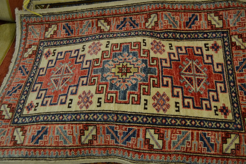 Two small 20th Century rugs both having hooked medallions with multiple borders