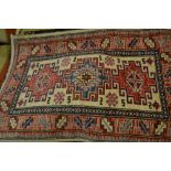 Two small 20th Century rugs both having hooked medallions with multiple borders
