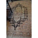 Indo Persian rug with a large pale green medallion design on a dark ground with beige borders