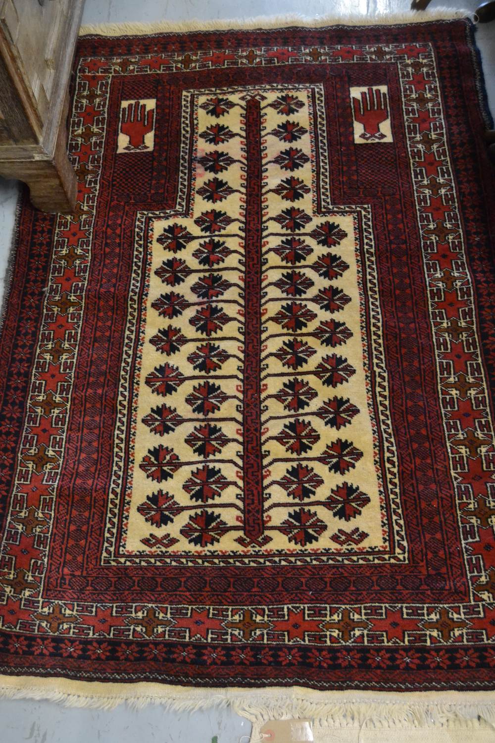 Belouch rug of geometric floral design with multiple borders on a wine ground