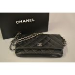 Small Chanel black quilted cross body handbag with authenticity card and original felt protector