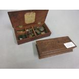 Small mahogany case containing a collection of various Troy weights,