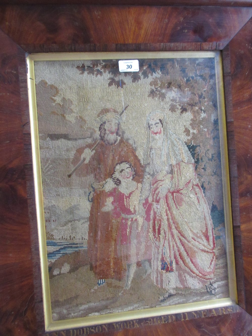 19th Century woolwork picture depicting figures in a landscape, inscribed Ann Dobson work,