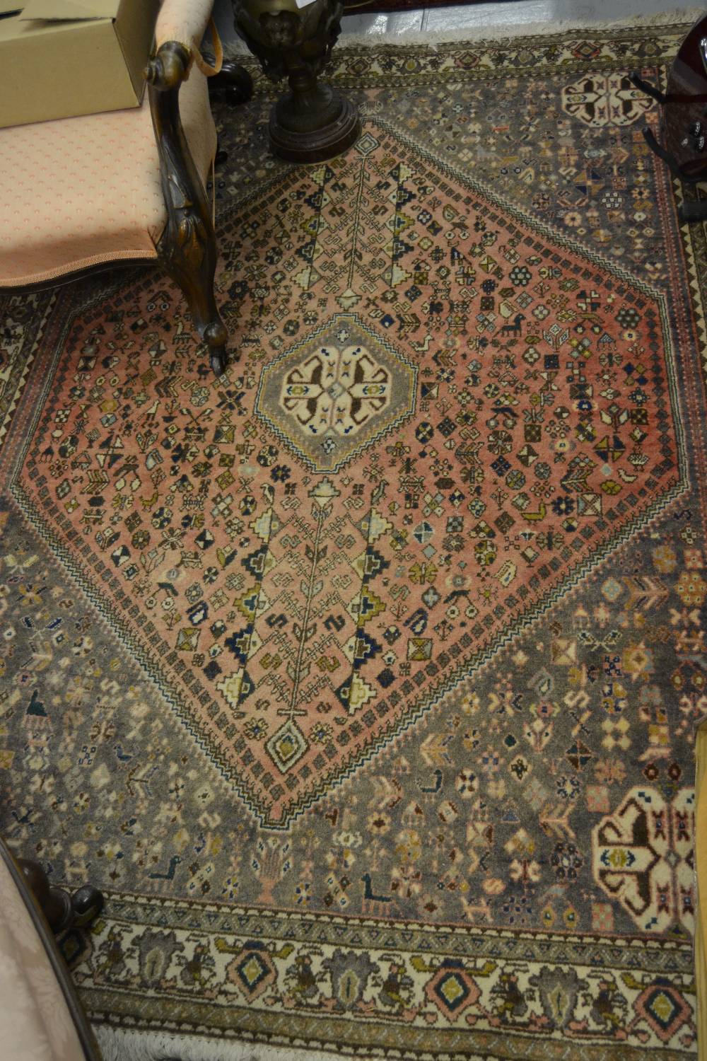 Modern Indo Persian rug with medallion and all-over stylised design on a rose ground with borders