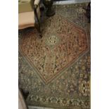 Modern Indo Persian rug with medallion and all-over stylised design on a rose ground with borders