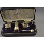 Birmingham silver three piece condiment set in fitted box (lacking one spoon)