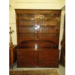 George IV mahogany bookcase, the moulded cornice above a pair of bar glazed doors enclosing shelves,