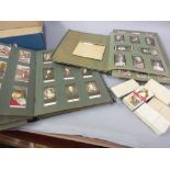 Two albums containing a quantity of cigarette cards and a small quantity of various loose cigarette