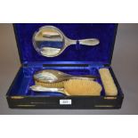 Cased four piece silver backed dressing table set