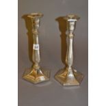 Pair of early 20th Century silver plated candlesticks having hexagonal bases and reeded columns