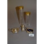 Three piece silver condiment set and two silver gilt mounted glass dressing table bottles