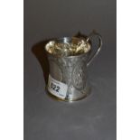 Small Victorian silver Christening mug of embossed waisted form with scroll shaped handle